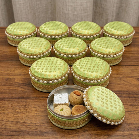 Lime green fabric covered steel ladoo boxes with gold embroidery pearl trim and metallic interior for festival sweets gift