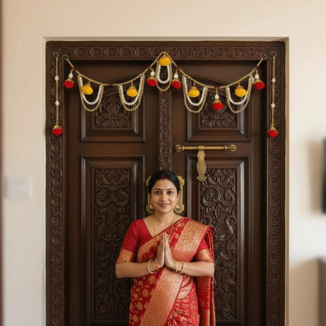 Woman in red sari standing before carved wooden door with festive garland for Diwali decor