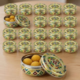 Yellow green Meenakari laddu tins with floral designs and golden sweets