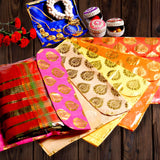Vibrant pink yellow and orange silk brocade sari bags with gold paisley designs and zipper closure for wardrobe storage and gifting