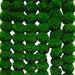 Vibrant green fluffy pom-poms arranged in a grid on artificial marigold flowers garland for festive home decor