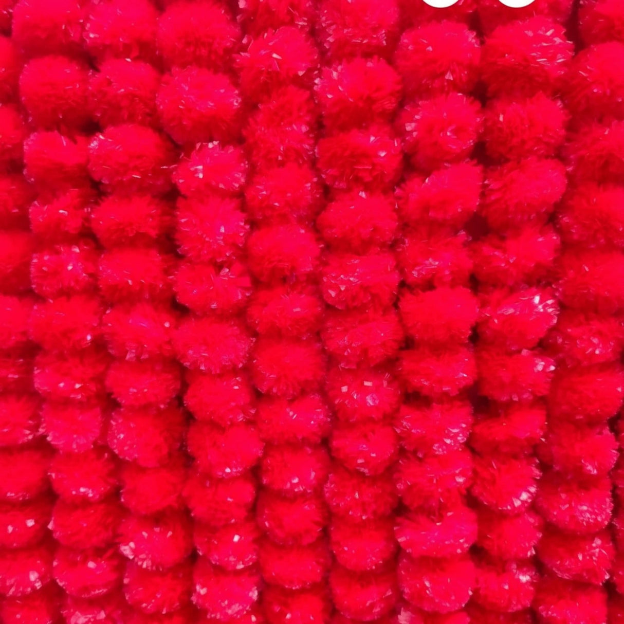 Bright red pom-pom garlands for Ugadi decoration in Indian decor arrangements