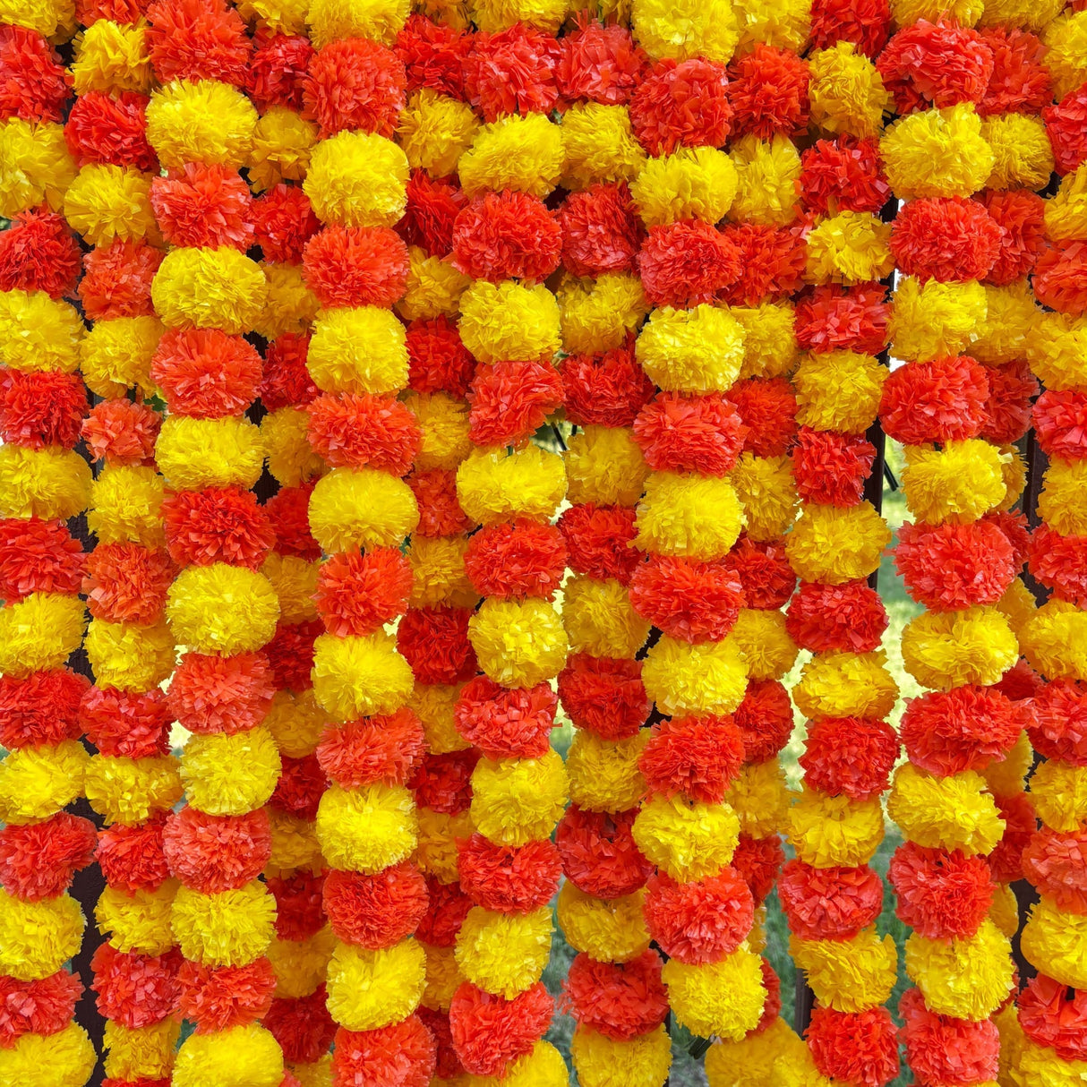 Strings of artificial red and yellow marigold flowers for Ugadi and Indian decoration