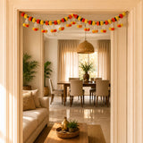 A vibrant orange yellow and black marigold jasmine door toran hanging valance for Diwali puja and festive decoration