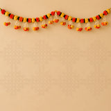 A 5 feet handcrafted marigold jasmine yellow orange door toran hanging valance with vibrant red yellow and black pom-poms