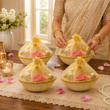 Beige ceramic bowls with gold trim and sheer yellow organza drawstrings holding pink roses in decorated gift basket for indian wedding baby shower engagement diwali housewarming return gifts