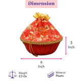 Red plastic drawstring pouch with gold floral embroidery and decorative trim for Indian wedding and festive gift basket