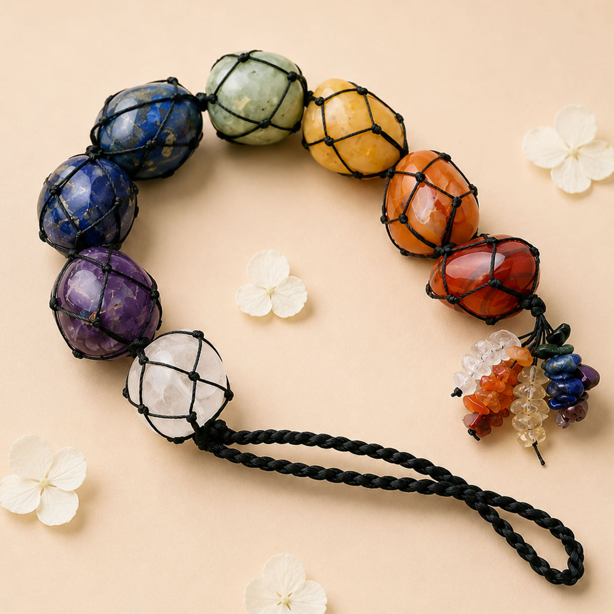 A handcrafted 7 chakra car hanging ornament with polished lapis lazuli, aventurine, citrine, carnelian, garnet, amethyst, and quartz beads
