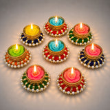 Set of 8 colorful floral-shaped diya tealight candle holders in gold red green and blue with pearl adornments for festive decor