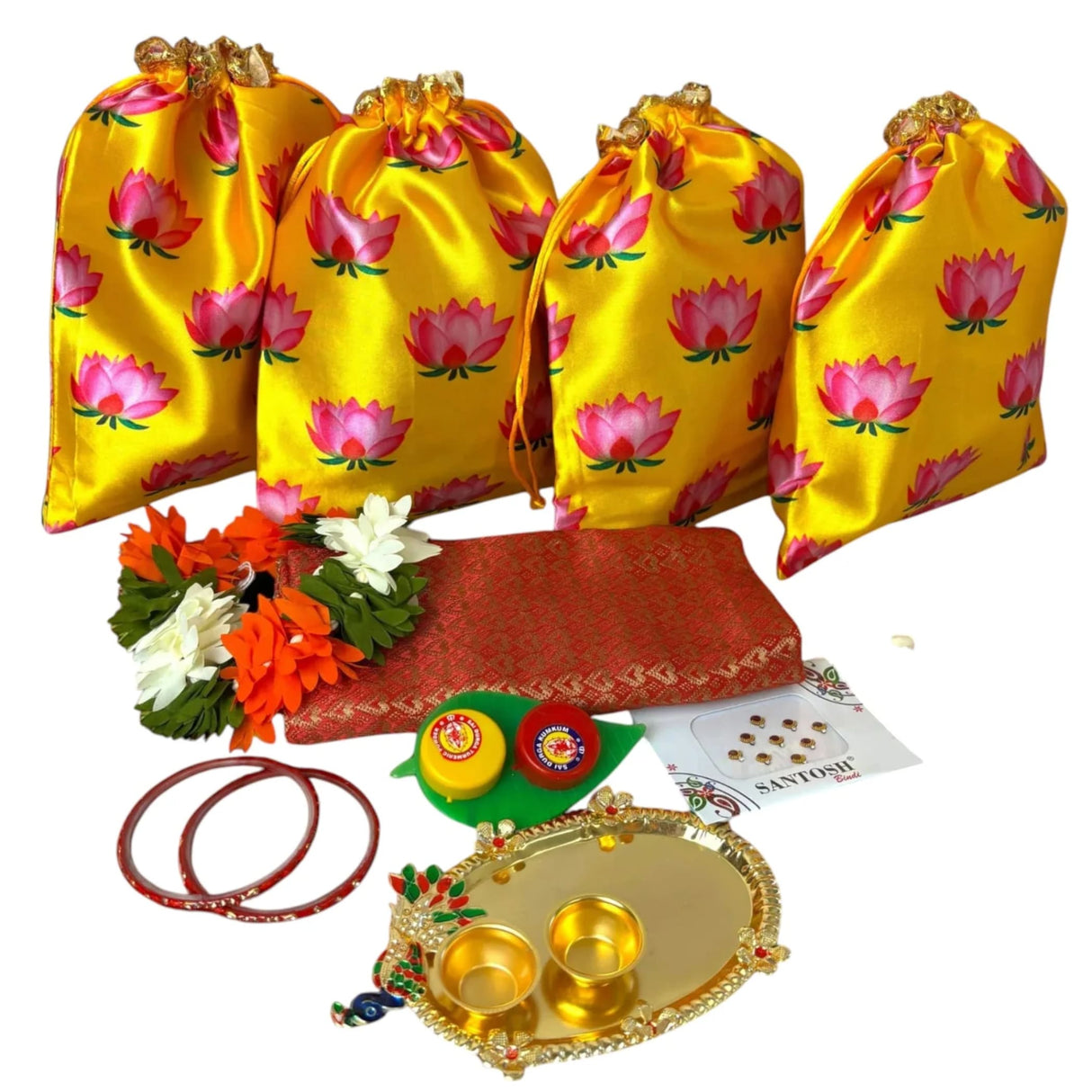 Four golden drawstring potli bags with pink lotus prints for Varalakshmi Vratham gifts