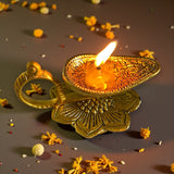 Golden ornate Lotus brass diya oil lamp with lit candle for Diwali puja