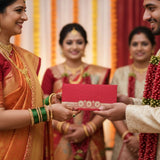 Vibrant red lucky shagun envelope with gold circular patterns for weddings