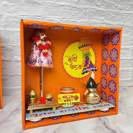 Vibrant Gudi Padwa decoration box with orange festive display, dolls, motifs, gathi mala, kalash