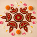Red and gold decorative rangoli designs in symmetrical pattern acrylic diya floor rangoli for diwali and home decor