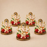 Set of five ornate cream acrylic ganesha idols with red green accents and gold detailing for home temple and festival decor