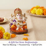 White and gold 2.25 inch acrylic Ganesh statue with purple orange accents