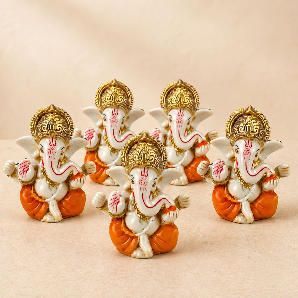 Acrylic ganesha idol featuring white and orange figurines with gold crowns and red markings for home temple decor
