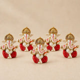 Set of five acrylic ganesha idols with white bodies red dhotis and gold crowns for home temple and festival decor