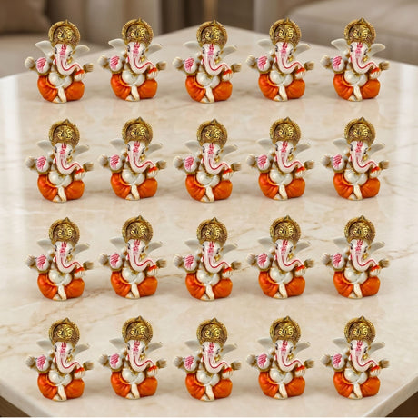 Set of fifteen acrylic ganesha idols with white body orange dhoti and golden crown for home temple and festival decor