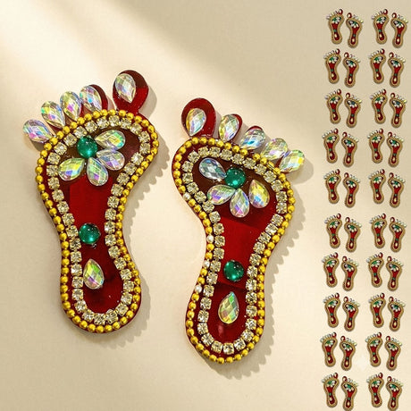 Red and gold embellished acrylic lakshmi charan paduka feet with iridescent crystals and green gemstones for diwali decor
