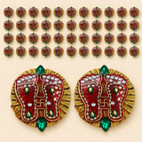 Acrylic lakshmi charan paduka foot-shaped decorative pins embellished in red and gold with green gemstones for diwali decor