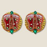 Red and gold embellished acrylic lakshmi charan paduka feet pins with green teardrop stones for diwali decoration