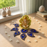 Golden ganesha figurine with intricate detailing seated on vibrant green leaf base acrylic rangoli set for diwali decor