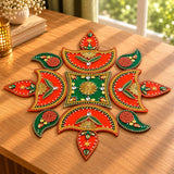Acrylic rangoli set with vibrant red and green decorative design featuring gold accents and rhinestones for Indian decor