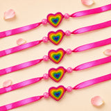 Bright pink satin ribbon animal theme rakhis with rainbow heart charm and adjustable thread for brother gift set