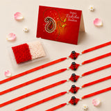 Five red silk animal theme rakhi bands with black ladybug charms and white pearl accents for brother protection gift