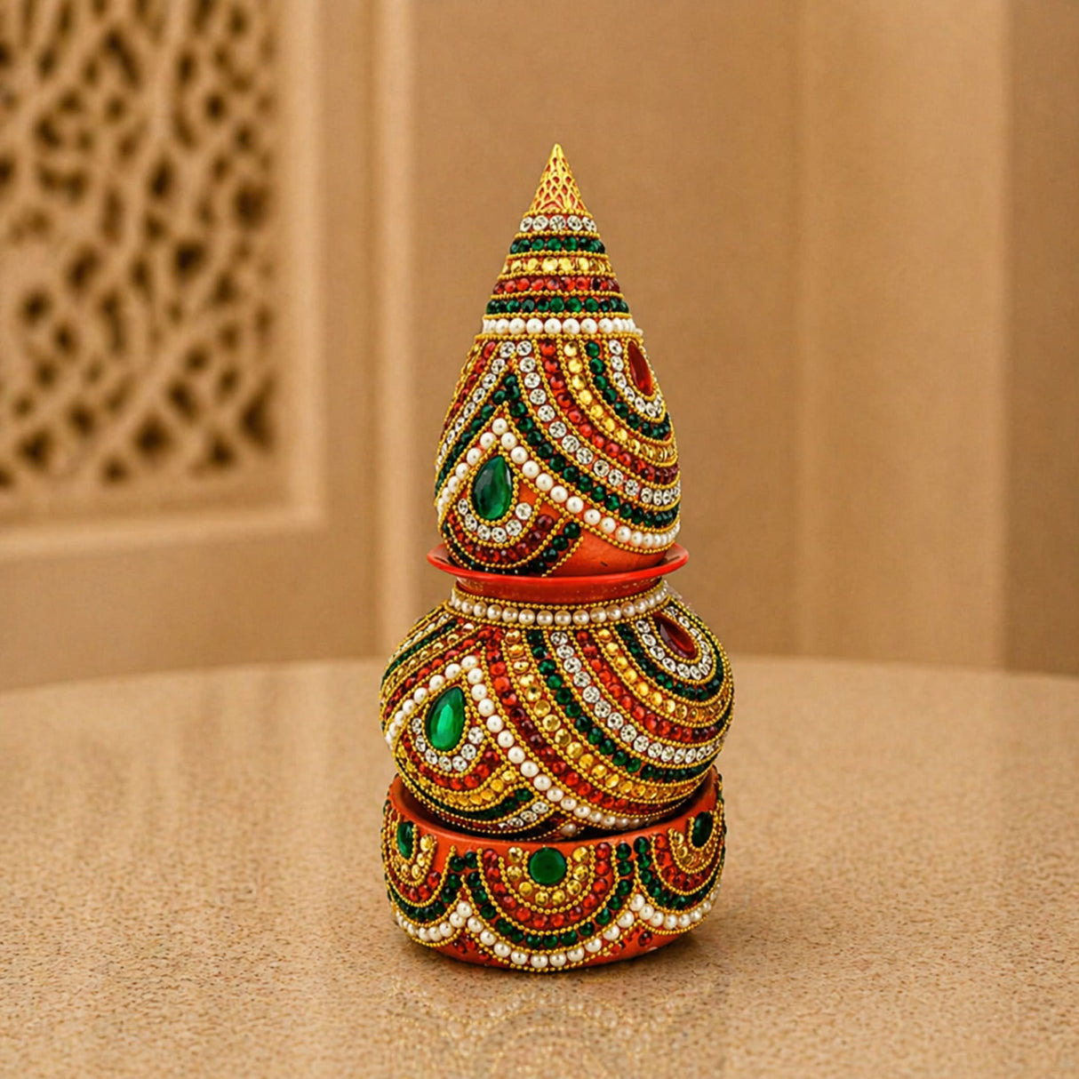 A vibrant multi-tiered artificial mangal kalash decorated with gold red green white beadwork and gemstones for pooja