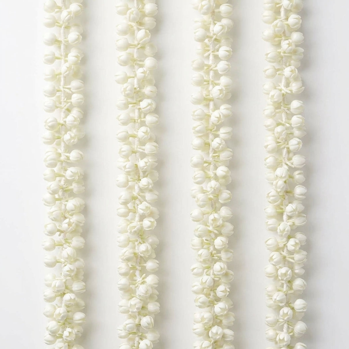 Four artificial jasmine garlands with delicate white buds for festivals