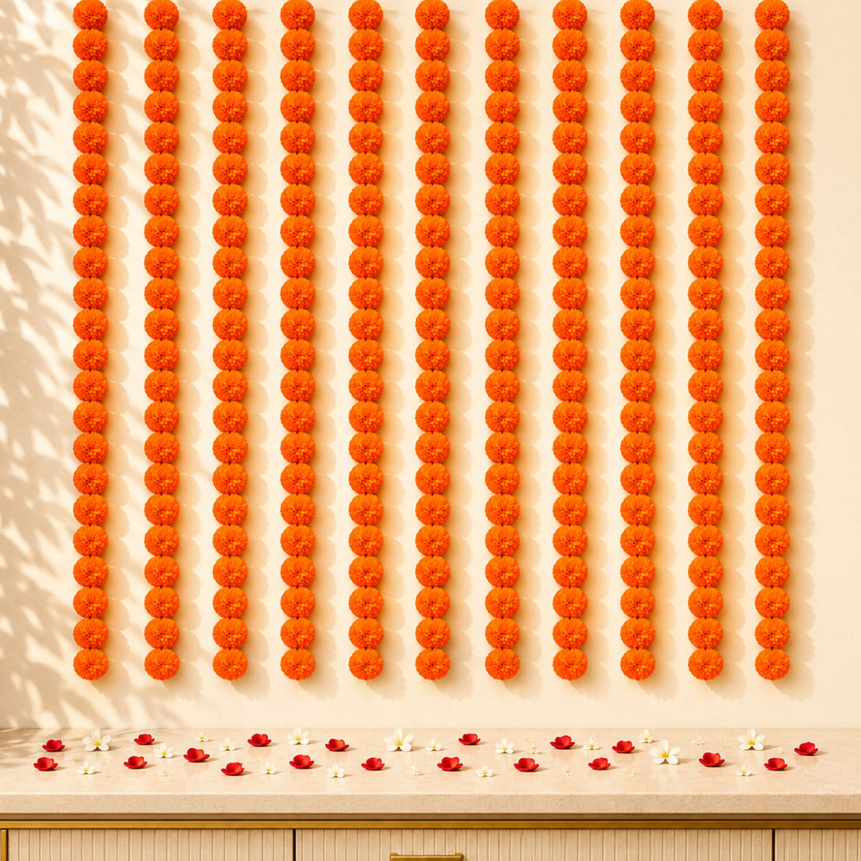 Artificial vibrant orange marigold flower garlands arranged in neat vertical rows for diwali and pooja decoration