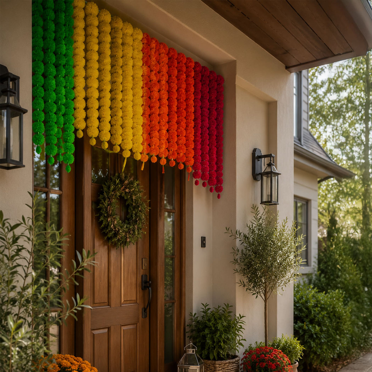 A vibrant rainbow-colored artificial marigold flower garland hanging above a wooden door for diwali and pooja decoration