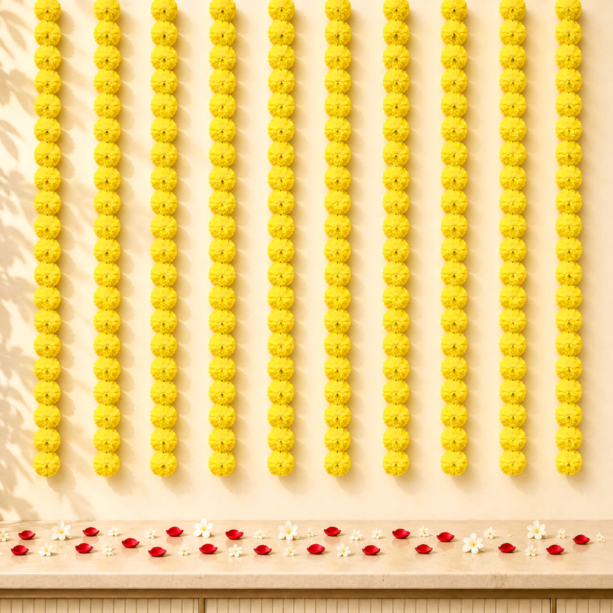 Rows of vibrant yellow artificial marigold strings arranged in neat vertical lines for diwali and pooja decoration