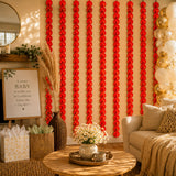 Red paper artificial marigold strings hanging vertically for diwali decoration and pooja backdrop use