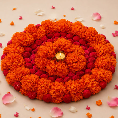 Vibrant orange and red artificial marigold flower rangoli with central candle for Ugadi decor and festive pooja use