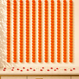 Set of 5 strings artificial vibrant orange marigold garland arranged in neat rows for wedding and festive decor