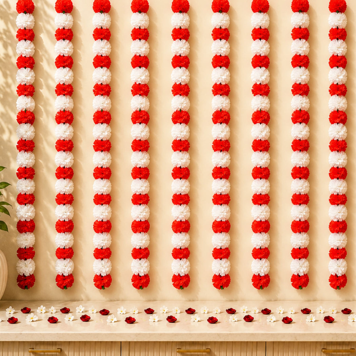Artificial marigold garland string in red and white hanging in vertical rows for indian festival and party decorations