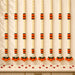 Elegant white and orange artificial marigold flower garlands with black accents for diwali and day of the dead decor