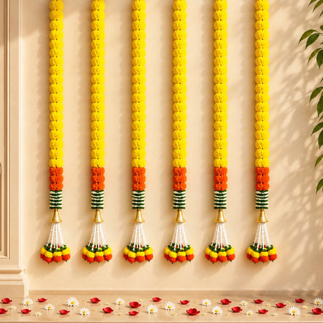 Artificial marigold garland with yellow and orange flowers green striped accents and golden cones for festive décor