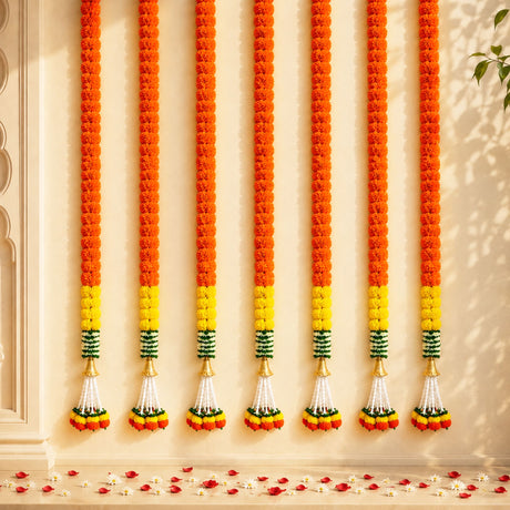 Set of 2 artificial vibrant orange marigold garlands with yellow green stripes and white tassels for festive decorations