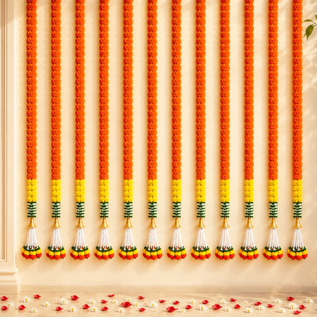 Artificial marigold garland with vibrant orange yellow flowers and green accents for festive decorations and home décor