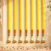 Six vibrant yellow artificial marigold garlands with orange and green bands and white flower tassels for festive decor
