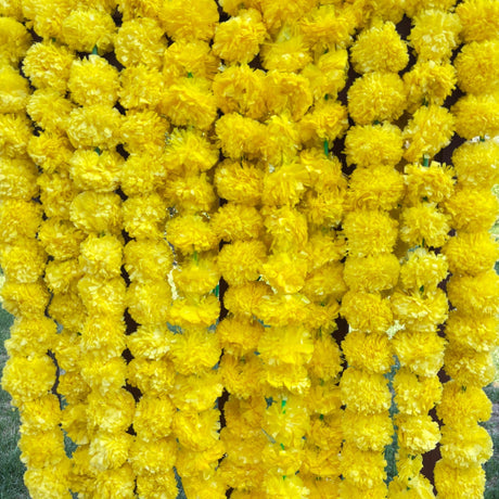 Yellow pom-pom garland with green accents for Diwali, Day of the Dead, or Halloween decoration