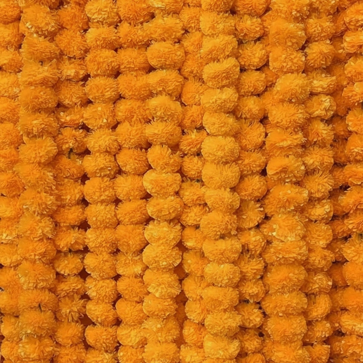 Orange pom-pom throw blanket with textured surface for Diwali, Day of the Dead, and Halloween decor