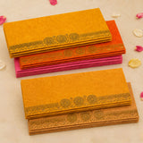 Stacks of vibrant orange and pink money envelopes with gold foil decorative wheel patterns for Indian wedding gifts