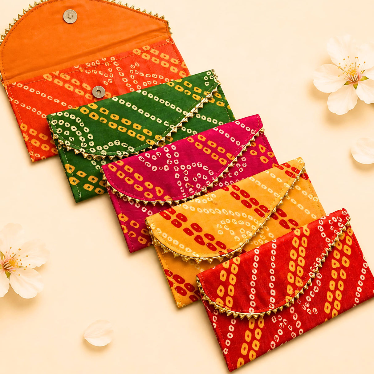 Vibrant brocade fabric money envelopes in orange green pink yellow and red with gold trim for indian wedding and gifting