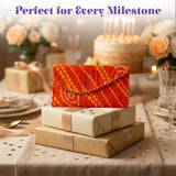 Vibrant orange brocade fabric money envelope with geometric pattern and decorative beaded edge for Indian weddings