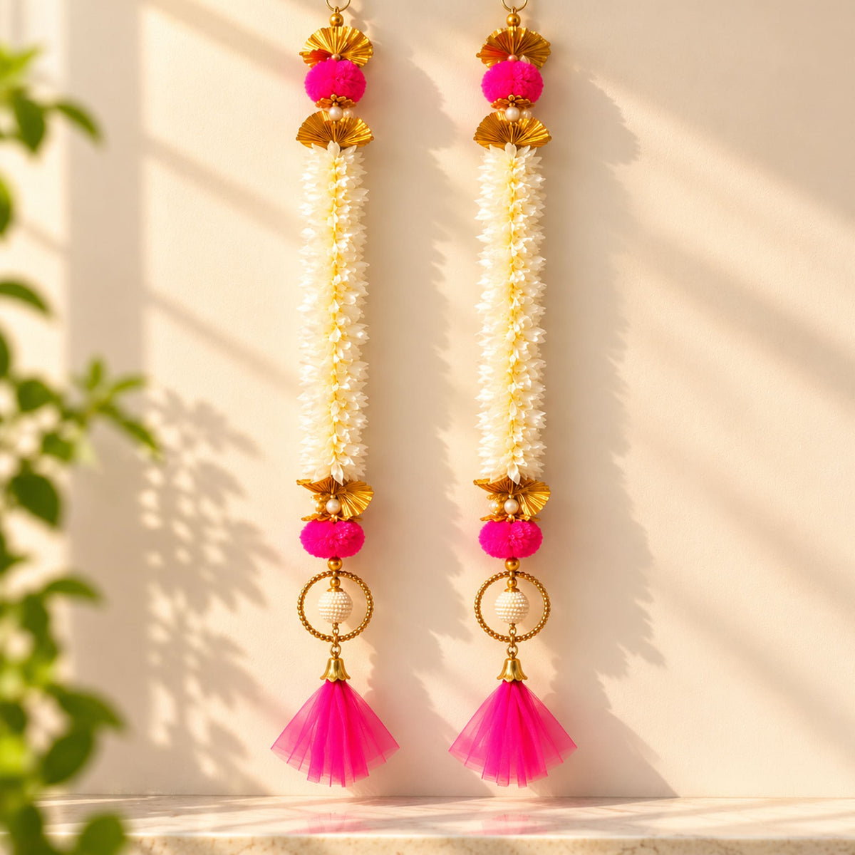 Bangle pom pom hanging backdrop garland in bright pink and gold with jasmine flowers for Indian festive decorations